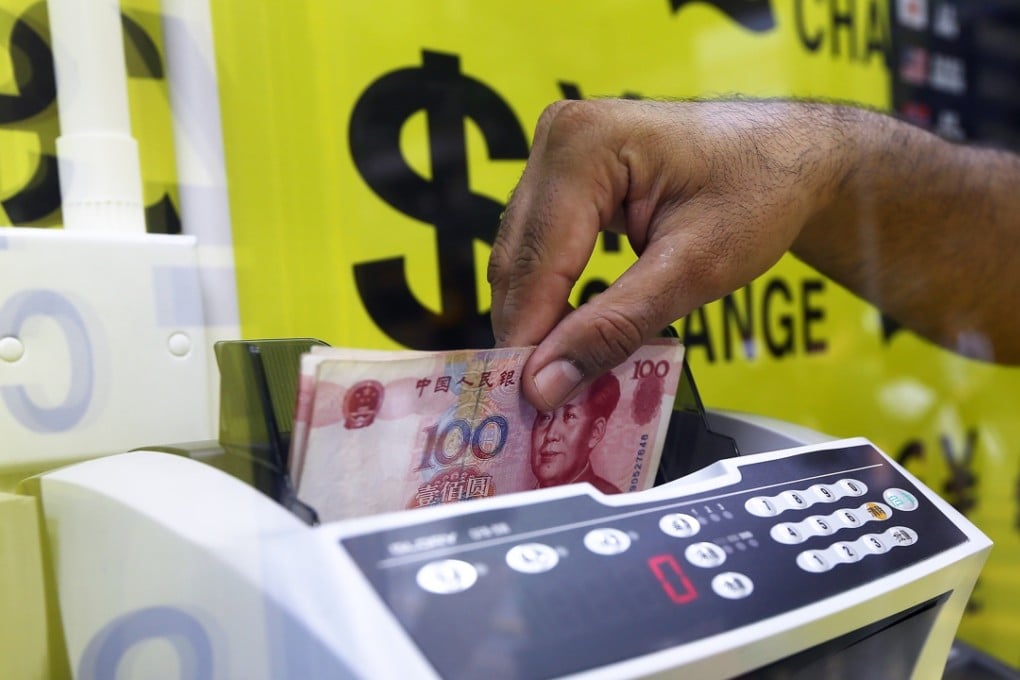 Yuan notes are counted at a currency exchange store in Hong Kong. Photo: Sam Tsang