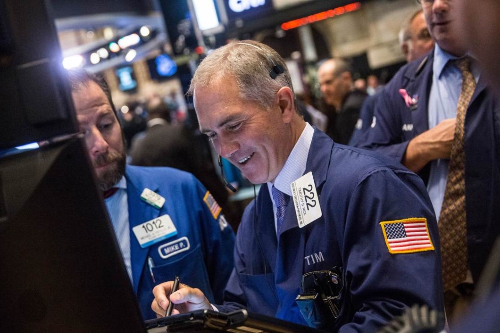 Traders work on the floor of the New York Stock Exchange as a lawsuit erupted between Bill Gross and his former employers at Pimco. Photo: AFP