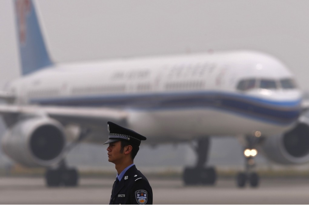 A policeman stands guard in front of a China Southern Airlines plane at Chengdu airport last year. Photo: Reuters