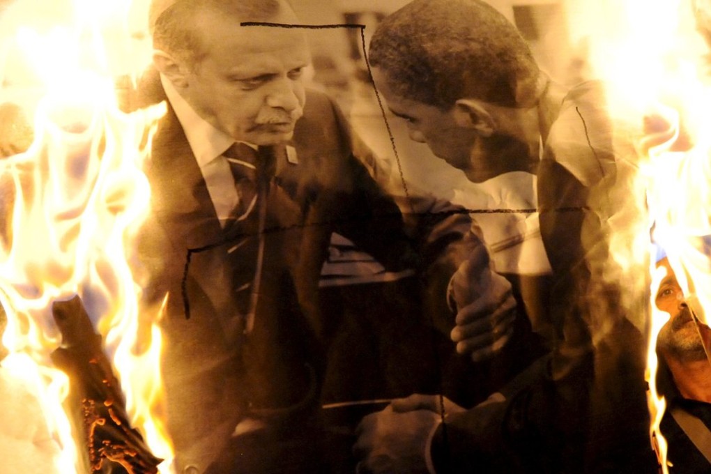 Protesters, angry over the Ankara bombings, set fire to a picture of Turkish President Tayyip Erdogan and US President Barack Obama in the northern city of Thessaloniki, Greece. Photo: Reuters