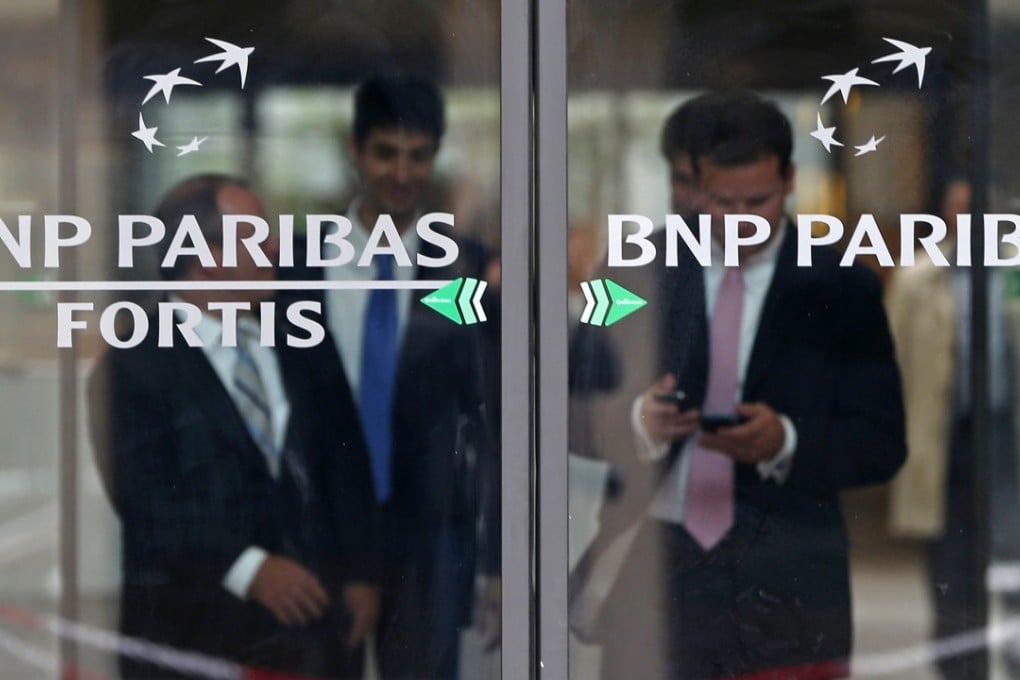 People leave BNP Paribas headquarters in Brussels after it was fined billions of dollars in the US for violating sanctions. Photo: Reuters