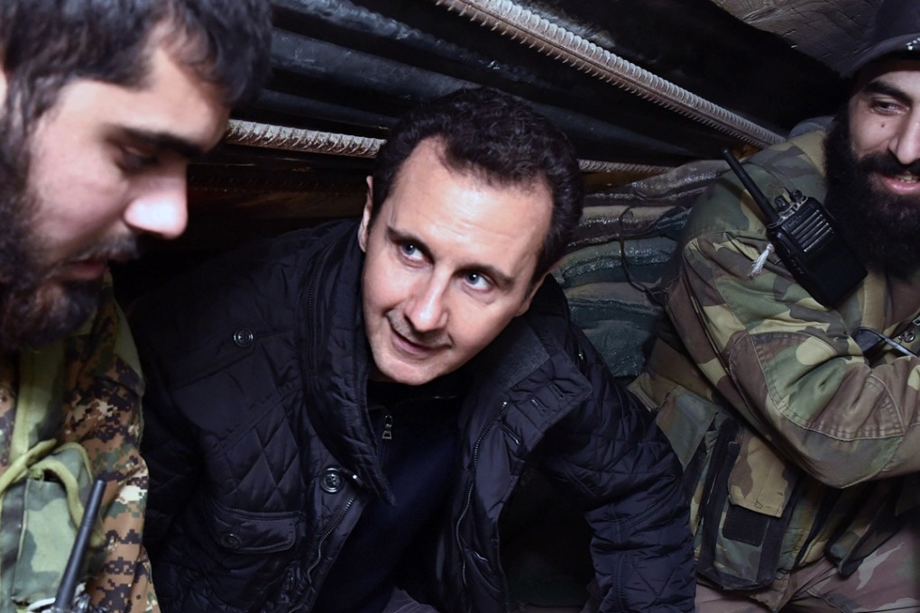 Syrian President Bashar al-Assad (centre) speaks with Syrian troops during his visit to the front line. Photo: AP