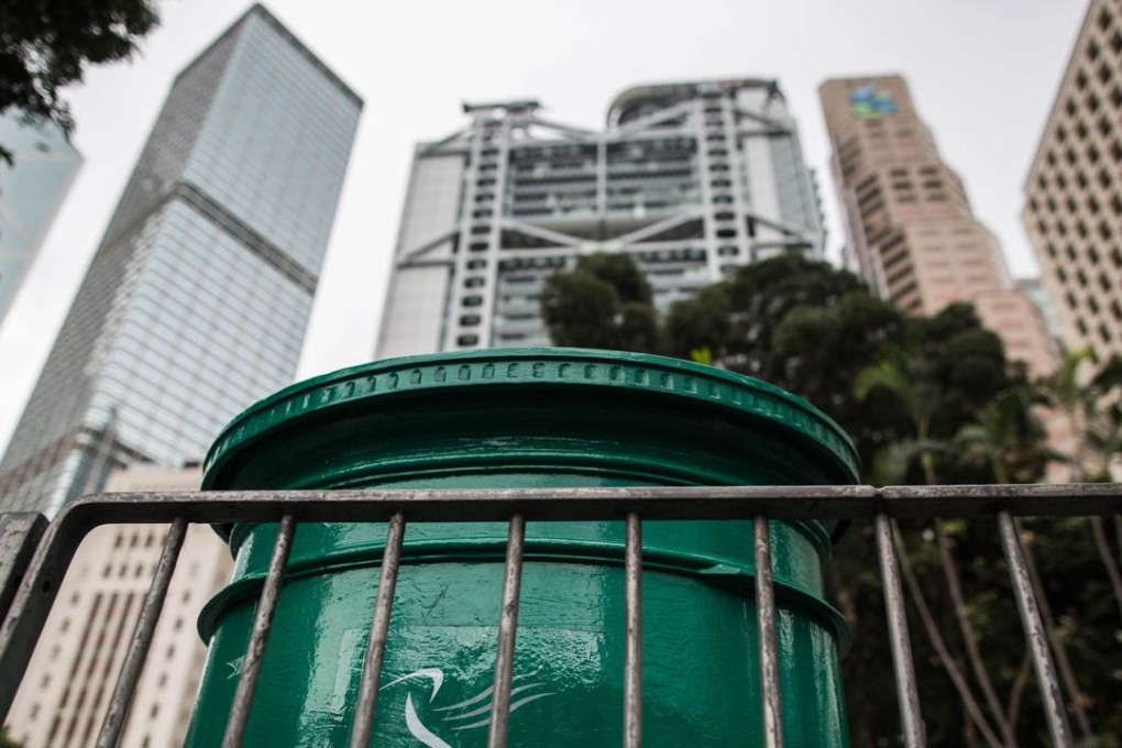 A British colonial-era mail box (C), which was painted from red to green after the city reverted to Chinese sovereignty in 1997, is pictured in the Central district of Hong Kong. Photo: AFP