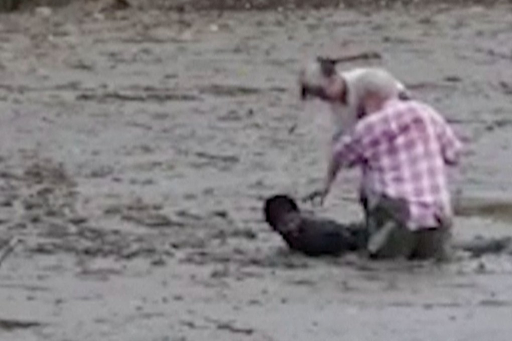 In the video provided by Theerasak Saksritawee, Thai construction worker Chat Ubonchinda lies in the mud as he helps two Norwegian birdwatchers who were sinking into a mudflat in Krabi, southern Thailand. Photo: AP