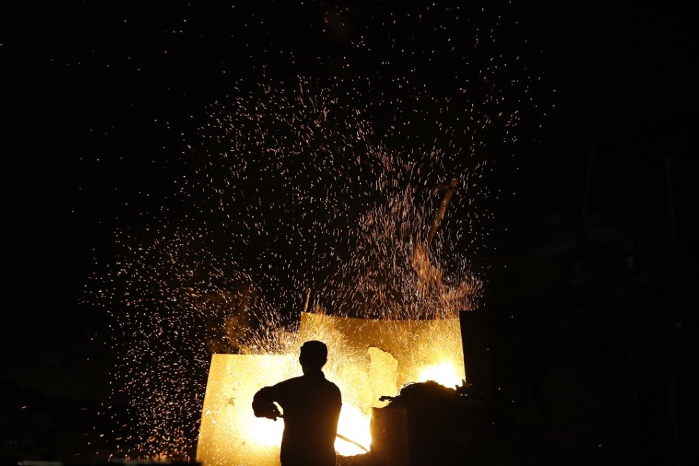 A worker produces aluminium ingots at a mill in Zhejiang province. Photo: Reuters