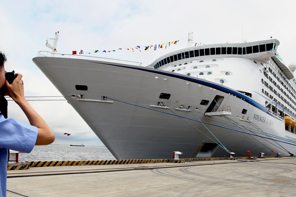 A woman takes picture of the cruise liner Voyager of the Seas in Shanghai. Photo: Xinhua