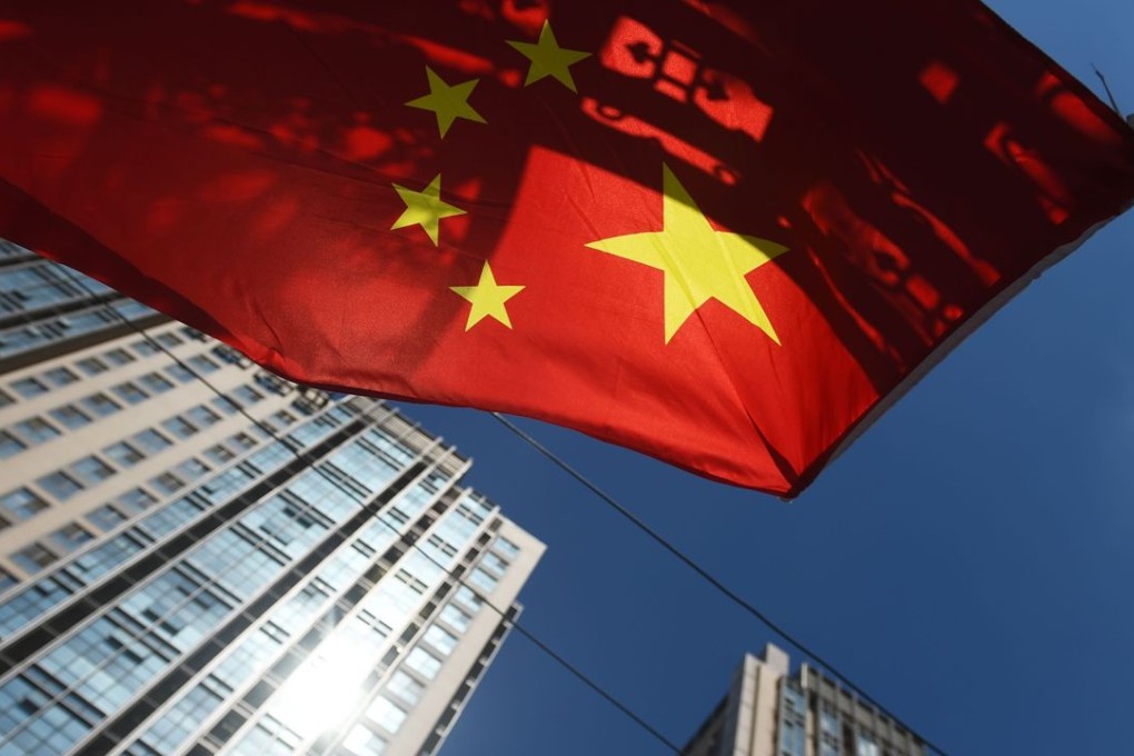 A Chinese flag flies near apartment buildings in Beijing as Chinese show record high interest in buying and trading up homes. Photo: AFP
