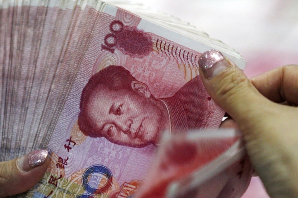 A bank clerk counts yuan at a bank outlet in Huaibei, Anhui province. Photo: Chinatopix via AP