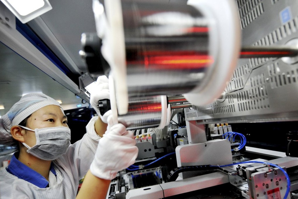 An employee on a production line producing solar energy products in Shangrao, Jiangxi province on October 1. Photo: Reuters