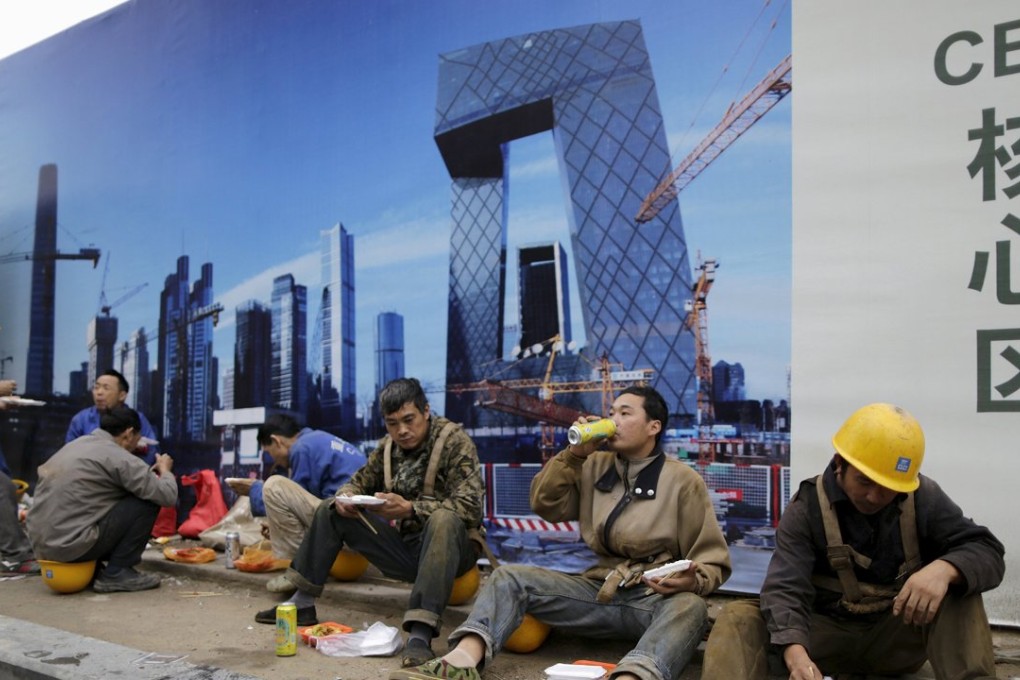 Construction workers have lunch outside a building site in Beijing, . Photo: Reuters