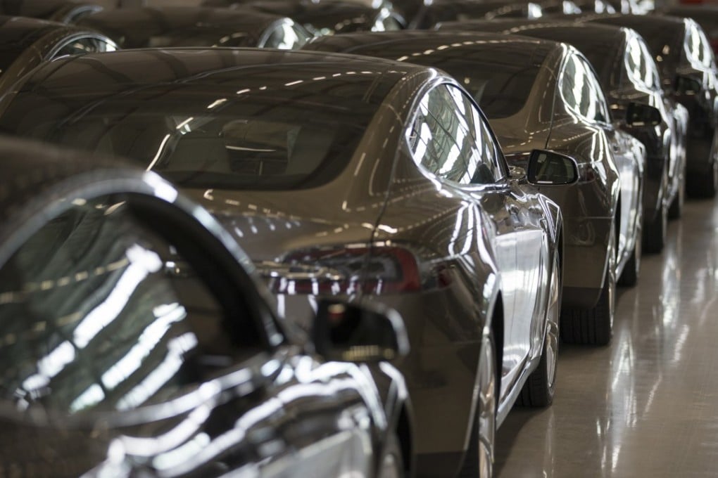 New Tesla Model S automobiles stand in a delivery area ahead of European shipping following final assembly at the Tesla Motors factory in Tilburg, Netherlands. Tesla said it delivered 11,580 vehicles in the third quarter, meeting its target after CEO Elon Musk handed over the first Model X SUVs just before the end of the period. Photo: Bloomberg