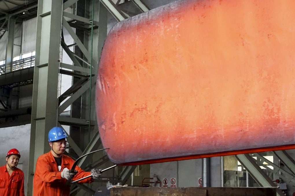 A worker measures a newly made steel block at a Dongbei Special Steel Group factory in Dalian, Liaoning province. Photo: Reuters