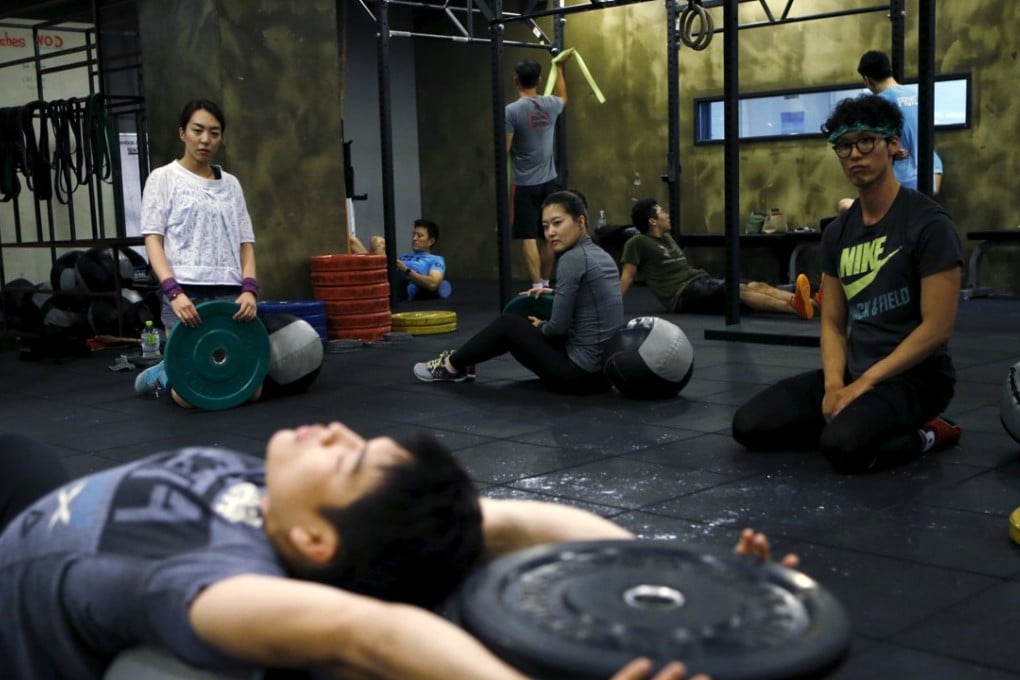 You Ri-seul, 29, and Kim Jin-ah (center), 31, take part in a crossfit class at a gym in Seoul on September 11. Photo: Reuters