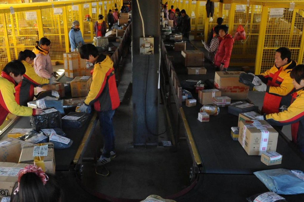 Express delivery workers sort packages for e-commerce houses such as Alibaba, whose shares in the United States rose on news that brokerages had raised their target prices on the stock. Photo: AFP