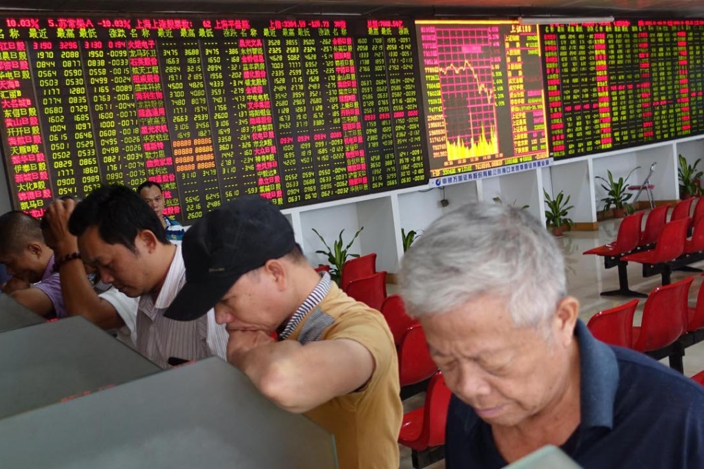 Investors look through stock information at a trading hall in a securities firm in Haikou, capital of south China's Hainan Province on October 21. Photo: Xinhua, Zhao Yingquan
