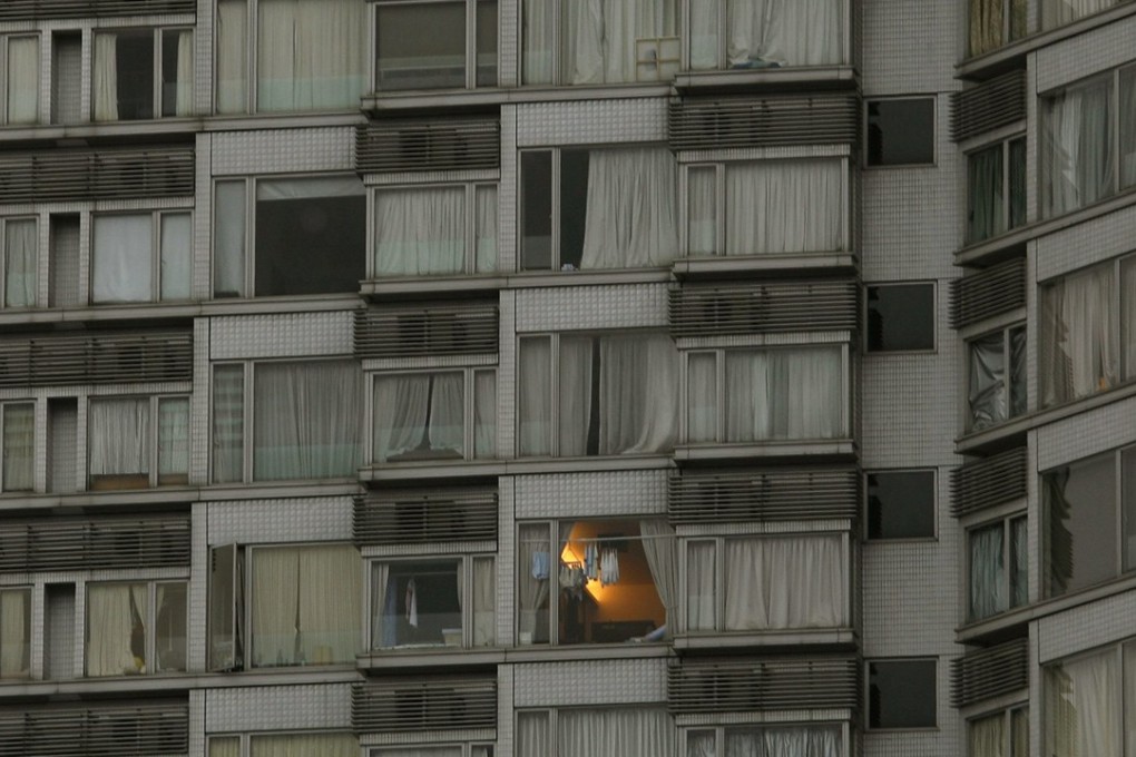 A unit is lit at a residential apartment building in Hong Kong as a company comes up with a scheme to offer 95 per cent of a loans’ value to sell small studios in the city. Photo: Reuters