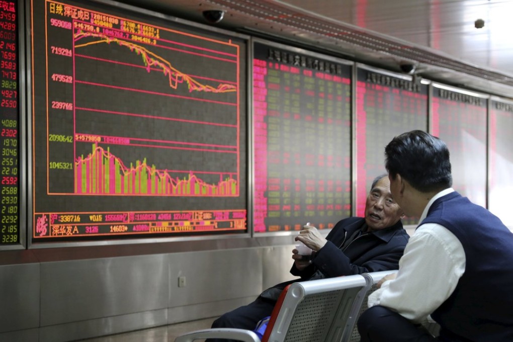 Investors chat in front of an electronic board showing stock information at a brokerage house in Beijing on October 30. Photo: Reuters