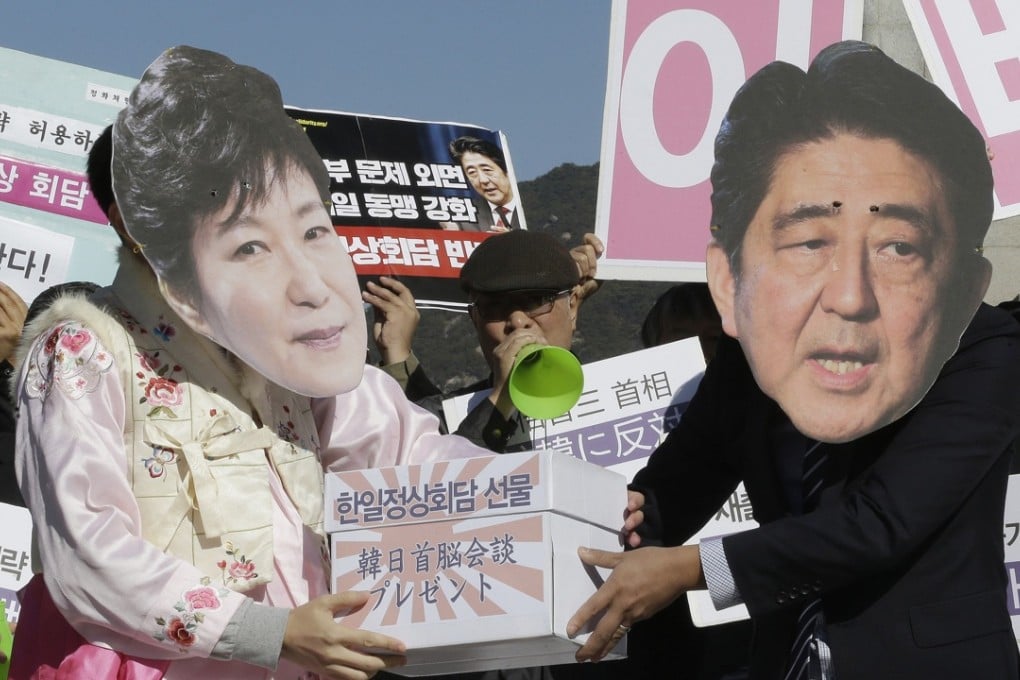 Protesters wearing masks of Japanese Prime Minister Shinzo Abe and South Korean President Park Geun-hye stage a rally against Abe’s planned visit in Seoul. Photo: AP