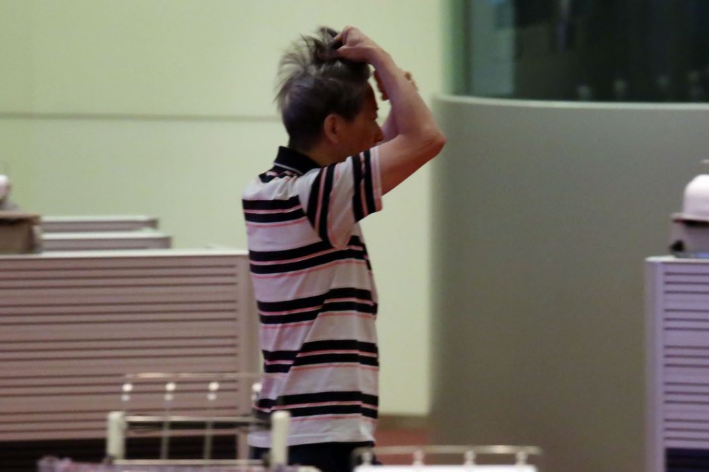 A floor trader on the Hong Kong Stock Exchange rubs his head while watching movements in the market as investors drift back into emerging market bonds after a sell-off in China. Photo: Nora Tam