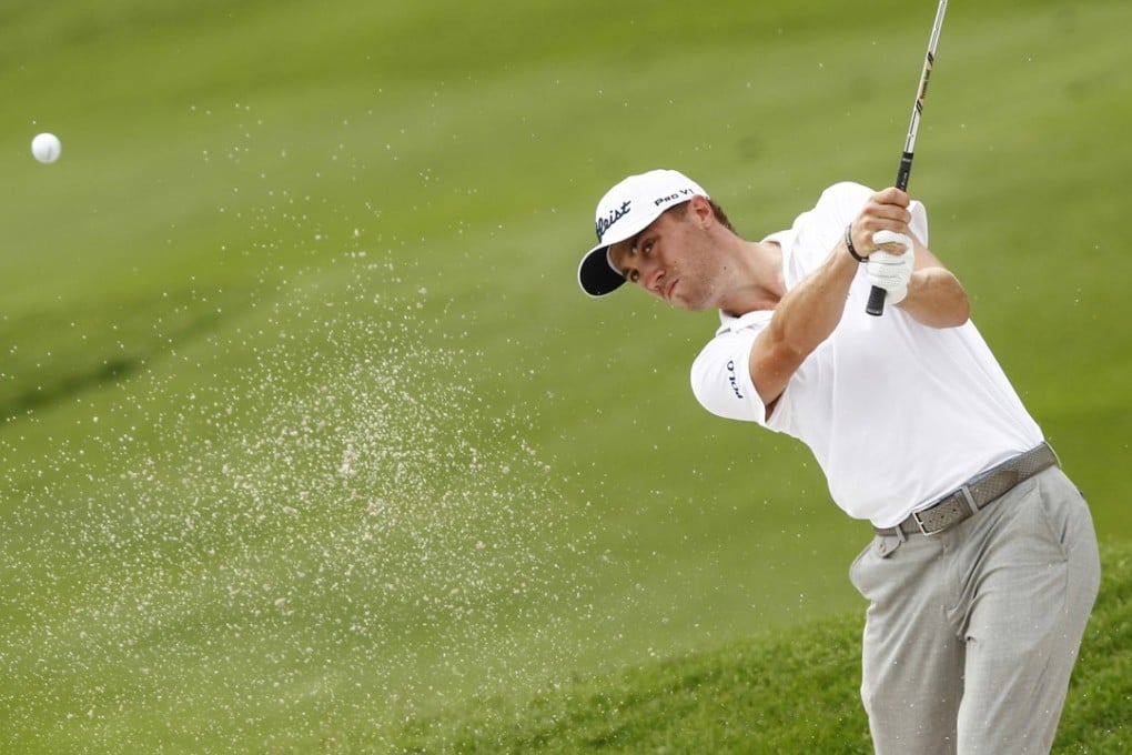 Justin Thomas of the US plays out of the bunker on the third hole during the final round of CIMB Classic. Photo: AP