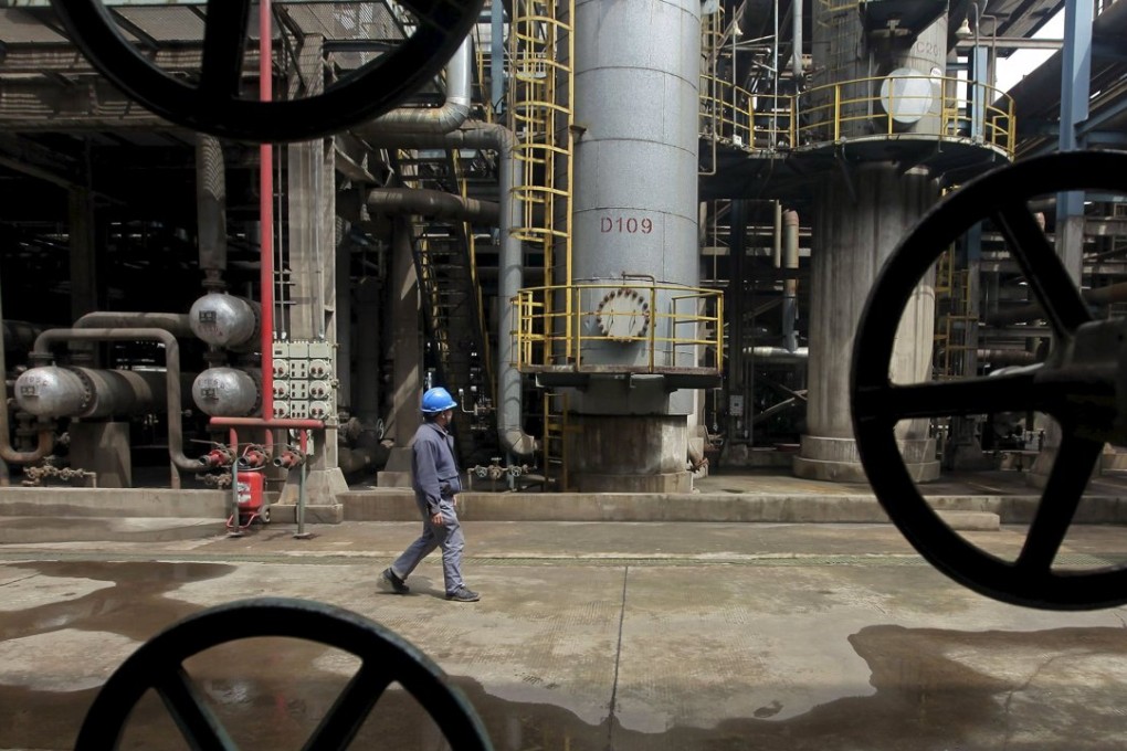 A worker walks past oil pipes at a refinery in Wuhan, Hubei province as China loadings of West African crude are seen bouncing back in November. Photo: Reuters