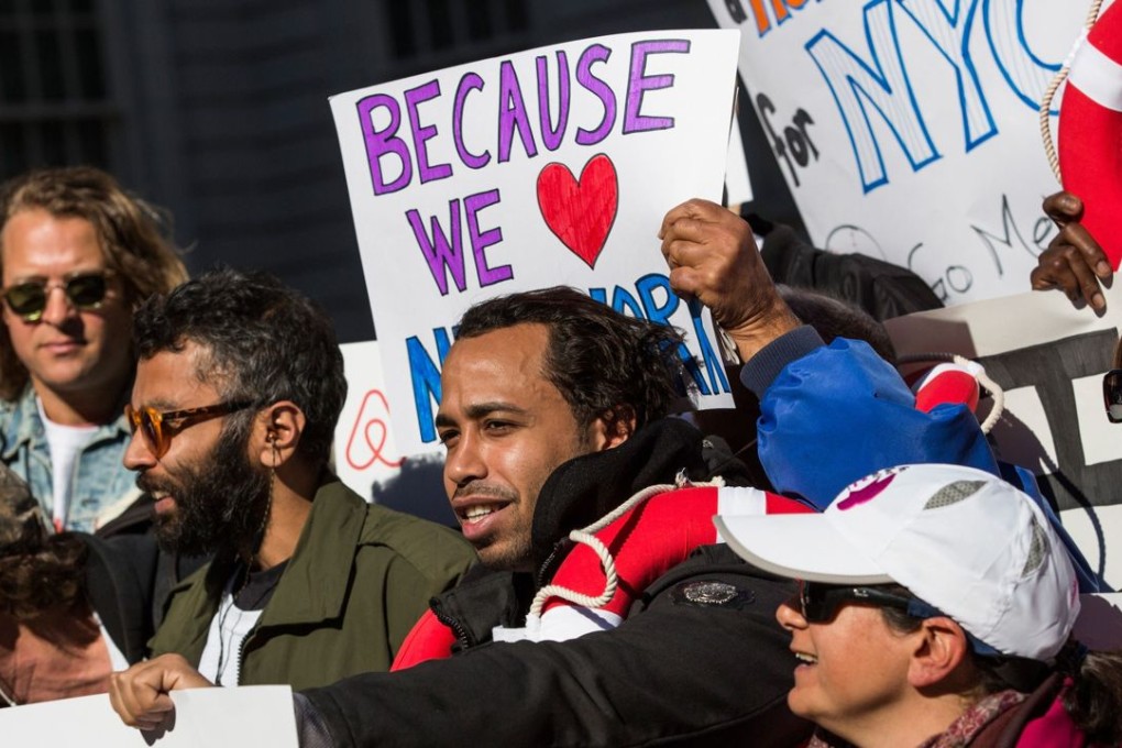 Supporters of Airbnb hold a rally on the steps of New York City Hall showing support for the company. Photo: AFP