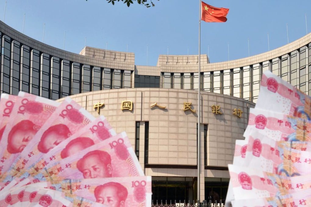The People's Bank of China can be seen amid banknotes of Chinese yuan. Photo: Kyodo