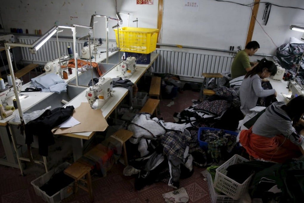 Seamstresses at work in a small-sized factory producing clothes and hats at the Qingyundian industrial zone in Beijing on October 19. More than half of its production line has shuttered because of a downturn in business. Photo: Reuters