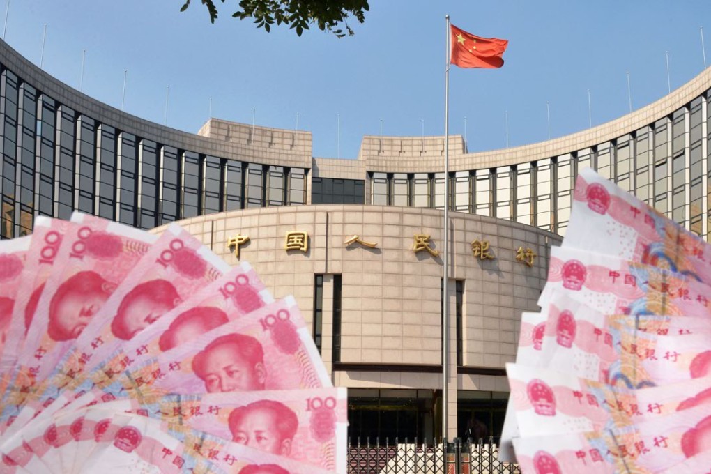 The People's Bank of China building and banknotes of the Chinese yuan. Photo: Kyodo