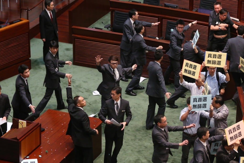 Lawmaker Wong Yuk-man threw a glass and some documents at Chief Executive Leung Chun-ying last year. Photo: K. Y. Cheng