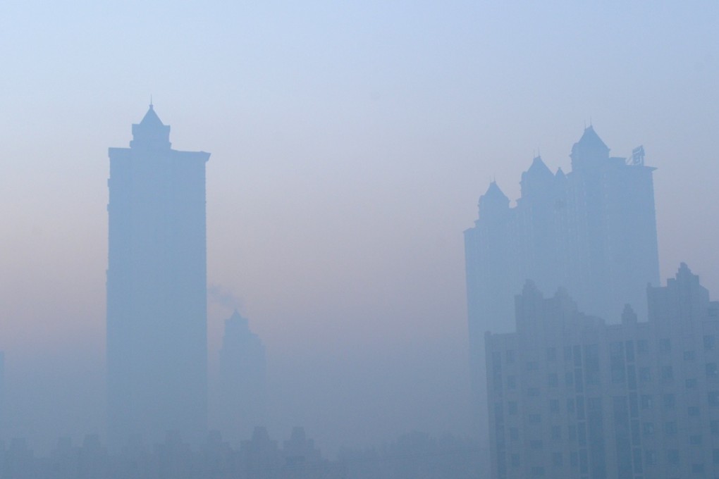 Buildings are cloaked in choking smog in China as analysts say investing in green companies may be the way to go in the future. Photo: EPA