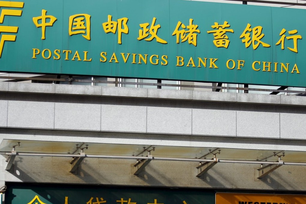 A man walks out of a Postal Savings Bank of China branch in Beijing which soon plans to close the sale of a 15 per cent stake to mainly foreign investors. Photo: Reuters