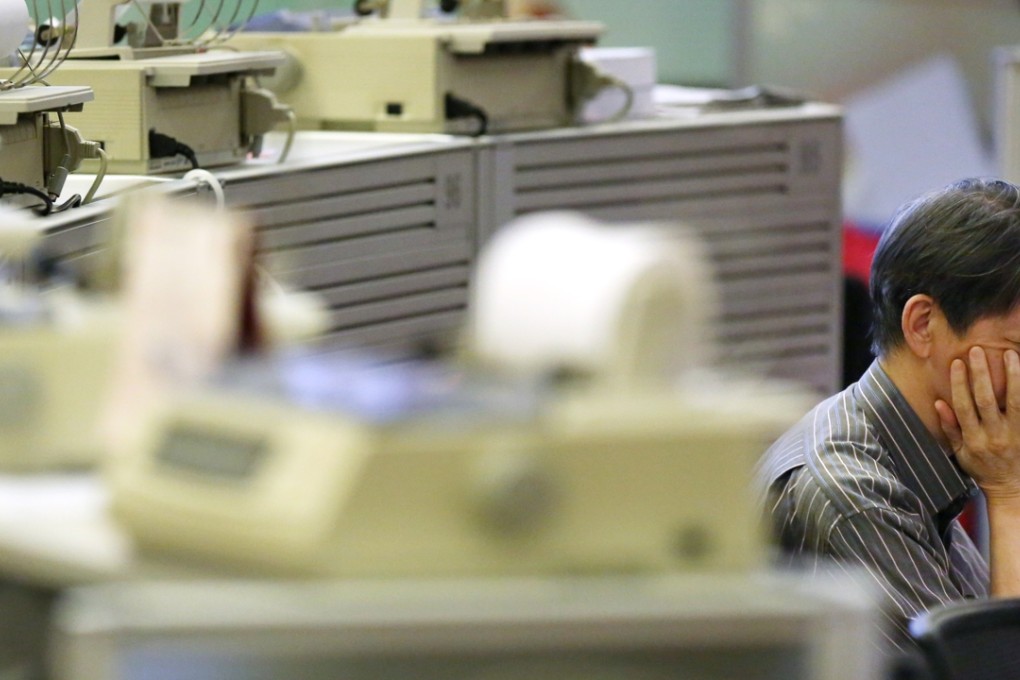 Stock brokers toil at their terminals at the The Hong Kong Stock Exchange in the city’s Central business district. Photo: Sam Tsang