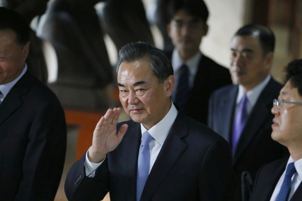 Chinese Foreign Minster Wang Yi, centre, leaves his talks with Philippine foreign secretary Albert Del Rosario. Photo: AP