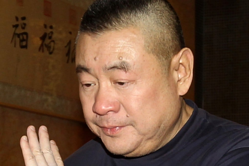 Tycoon Joseph Lau Luen-hung leaves the Fook Lam Moon restaurant in the Wan Chai district of Hong Kong. Photo: Edward Wong