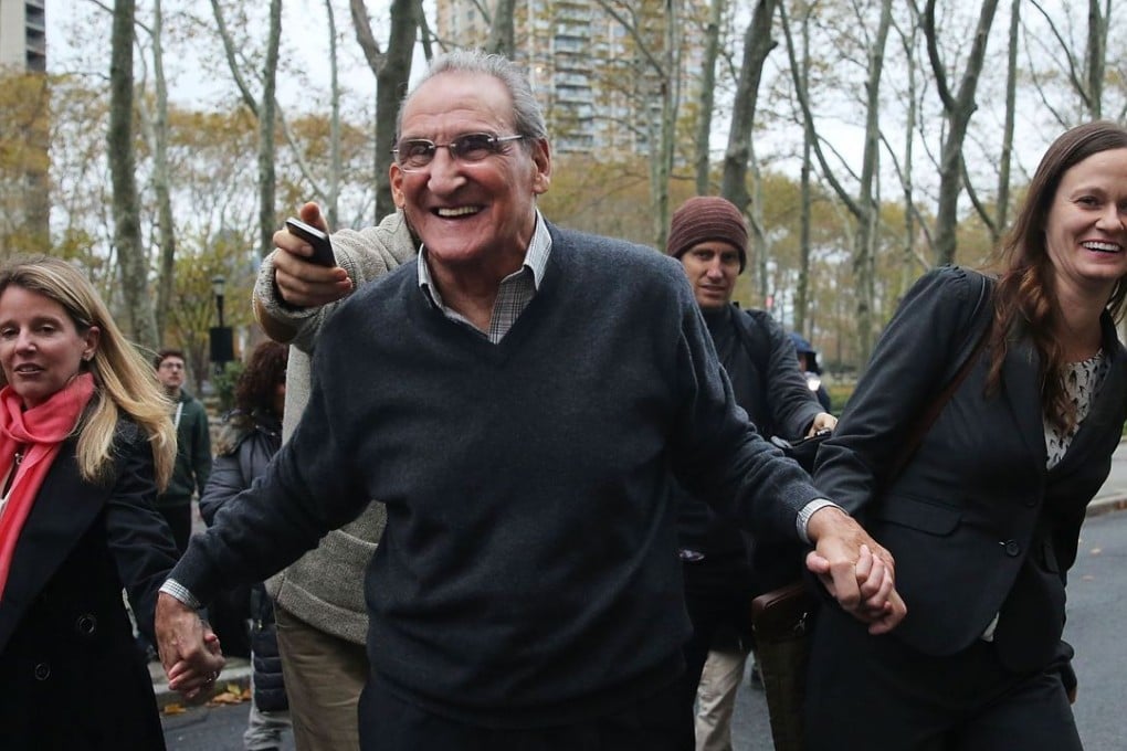 Vincent Asaro walks with his lawyers outside a Brooklyn court house after a jury found him not guilty of one count of racketeering conspiracy and two extortion-related counts. Photo: AFP
