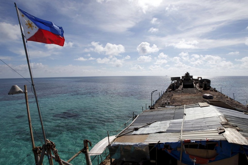 A Philippine national flag flutters aboard a vessel run aground on a disputed shoal that is part of the Spratly Islands in the South China Sea, in this 2014 photo. Photo: Reuters
