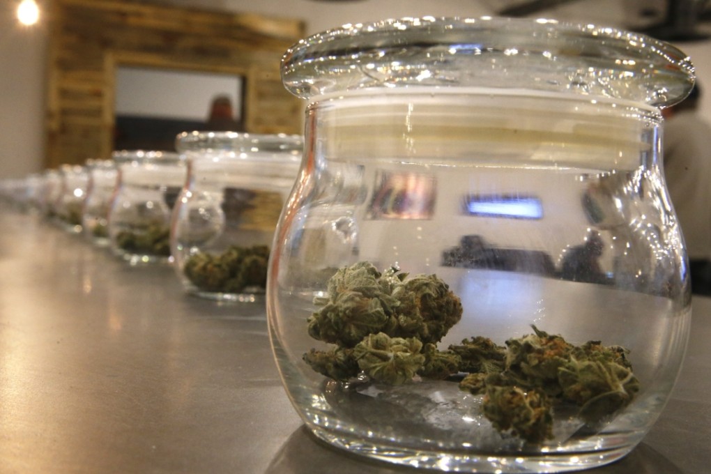 Marijuana for sale is kept in jars for customers to sample at the Colorado Harvest Company’s recreational marijuana stores in Aurora, Colorado. Photo: AP