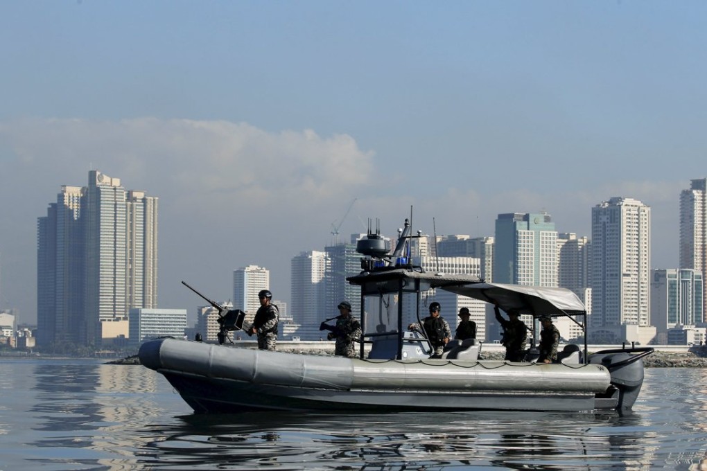 A Philippine Navy patrol boat guards the "no sail" restricted zone in Manila Bay, near the Apec summit venue. Photo: Reuters
