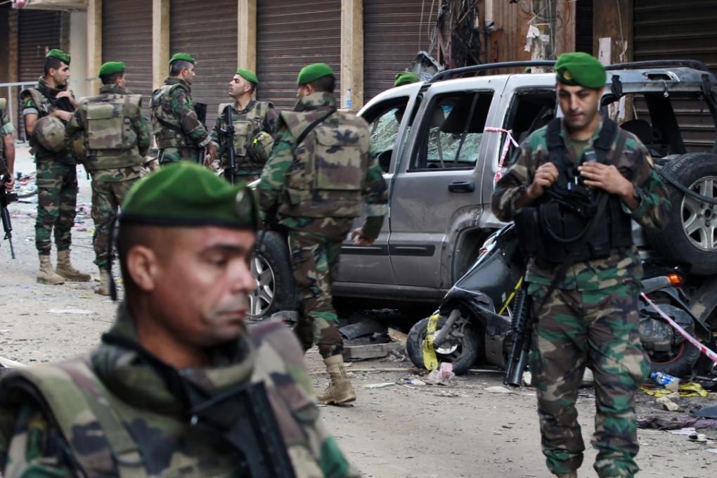 Lebanese soldiers stand guard at the site of Thursday's twin suicide bombings in Burj al-Barajneh, southern Beirut. Photo: AP