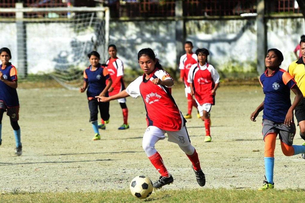Maria Manda (centre), captain of the high school soccer team in Kolsindur , Bangladesh, controls the ball during a match in the country’s capital, Dhaka. Photos: AFP