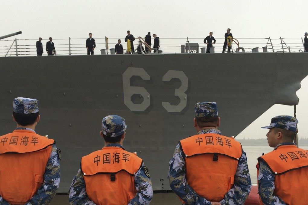 Chinese Navy personnel watch the guided missile destroyer USS Stethem arrive at the Shanghai International Passenger Quay for a scheduled visit. The docking was a sign that contacts between the US and Chinese militaries were continuing despite tensions over the South China Sea. Photo: AP