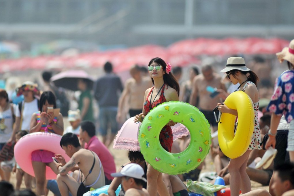 Visitors crowd a beach in Qingdao in July. Photo: AP
