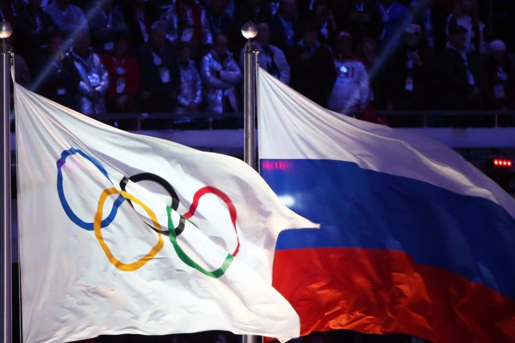 The Olympic flag and the Russian flag during the Closing Ceremony of the Sochi 2014 Olympic Games in Russia. Photo: EPA