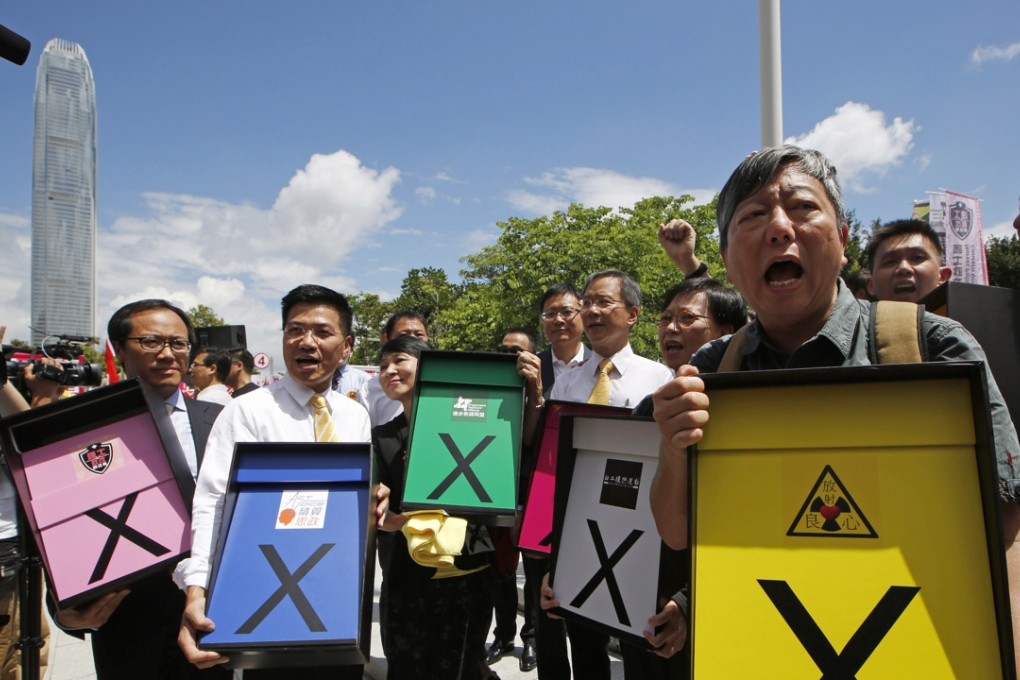 Pro-democracy lawmakers signalling their intention to vote against Beijing-backed political reform in June. Photo: AP