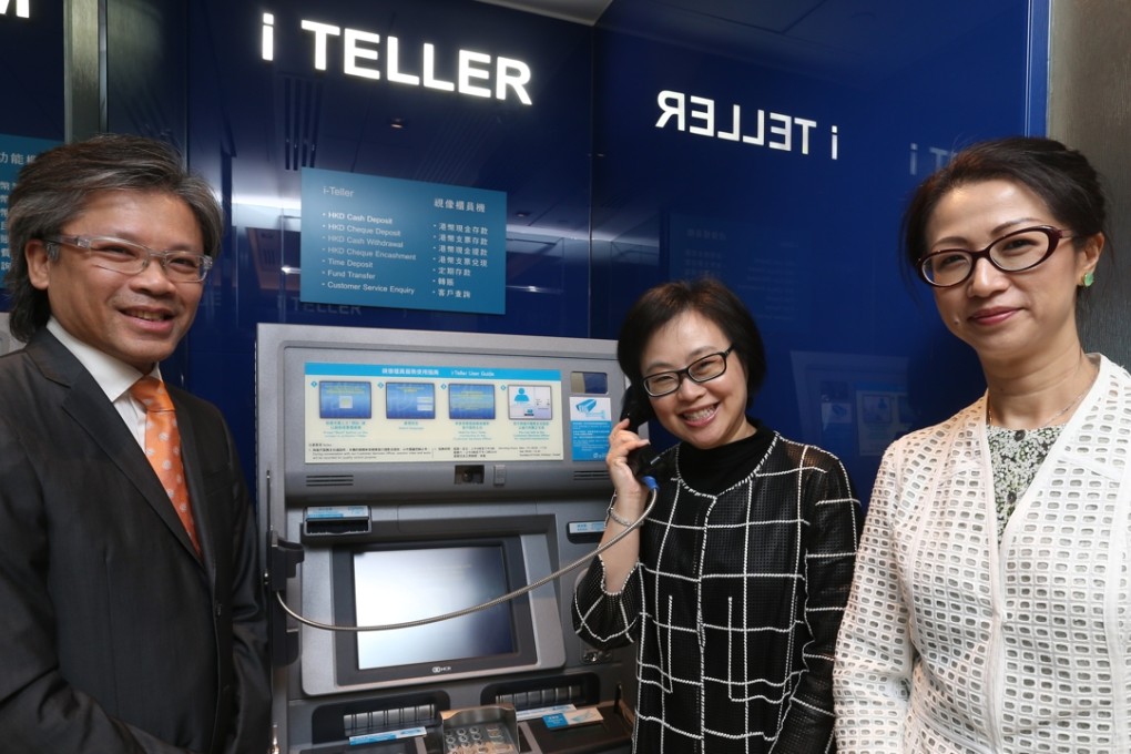 Depicted next to a virtual teller machine at a Fubon Bank branch in Wan Chai are NCR Hong Kong & Taiwan General Manager Keith Au (L), Fubon Bank(Hong Kong) Head of Retail Banking Group Executive Vice President Carmen Yip, and Fubon Bank (Hong Kong) Head of Channel & Wealth Management Division Senior Vice President Murine Tsien. Photo: K. Y. Cheng, SCMP