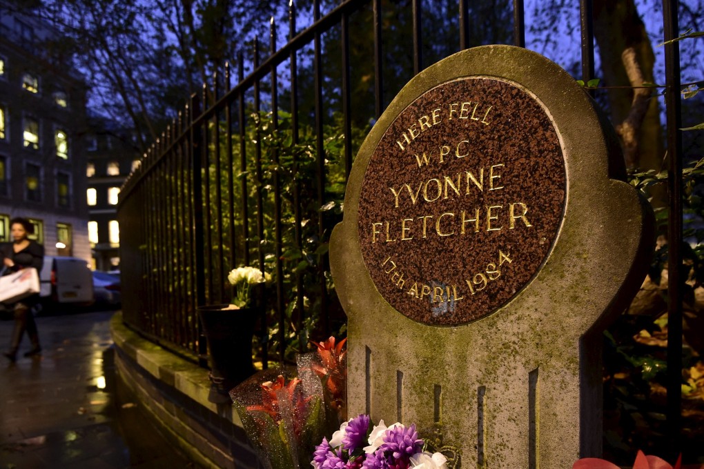 Flowers at a memorial plaque for police constable Yvonne Fletcher, in St. James's Square in London. Photo: Reuters