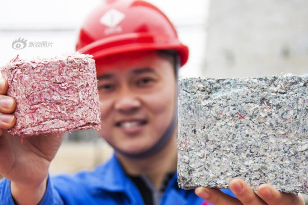 Bricks made out of old, damaged 100 yuan banknotes are burned and the leftover ashes turned into blocks that can be used for construction. Photo: Sina.com