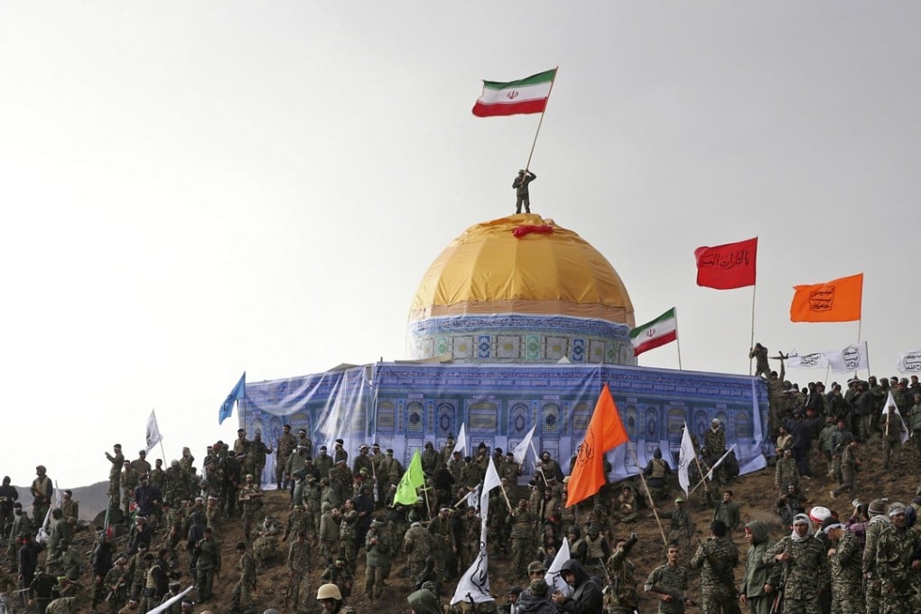 Members of the Basij, the paramilitary unit of Iran's Revolutionary Guard, gather around a replica of Jerusalem's gold-topped Dome of the Rock mosque as one of them waves an Iranian flag from on top of the dome. Photo: AP/Tasnim News Agency