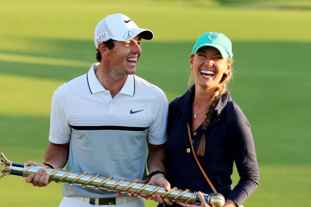 Rory McIlroy and his girlfriend Erica Stoll pose with the Race to Dubai Trophy . Photo: EPA